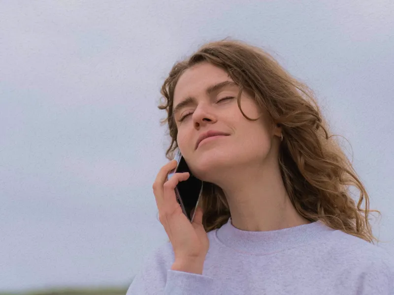 Person relaxing outdoors in nature after a telehealth session